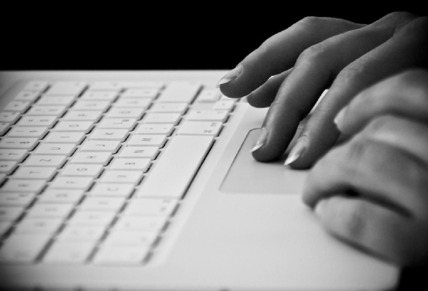 An individual working on a laptop