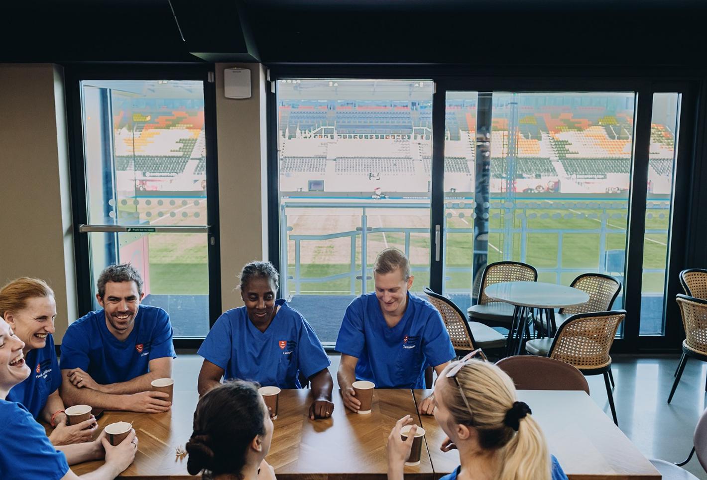 Nurses sitting roundtable West stand facility