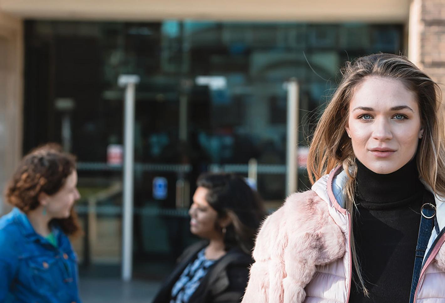 Female student stood outside campus