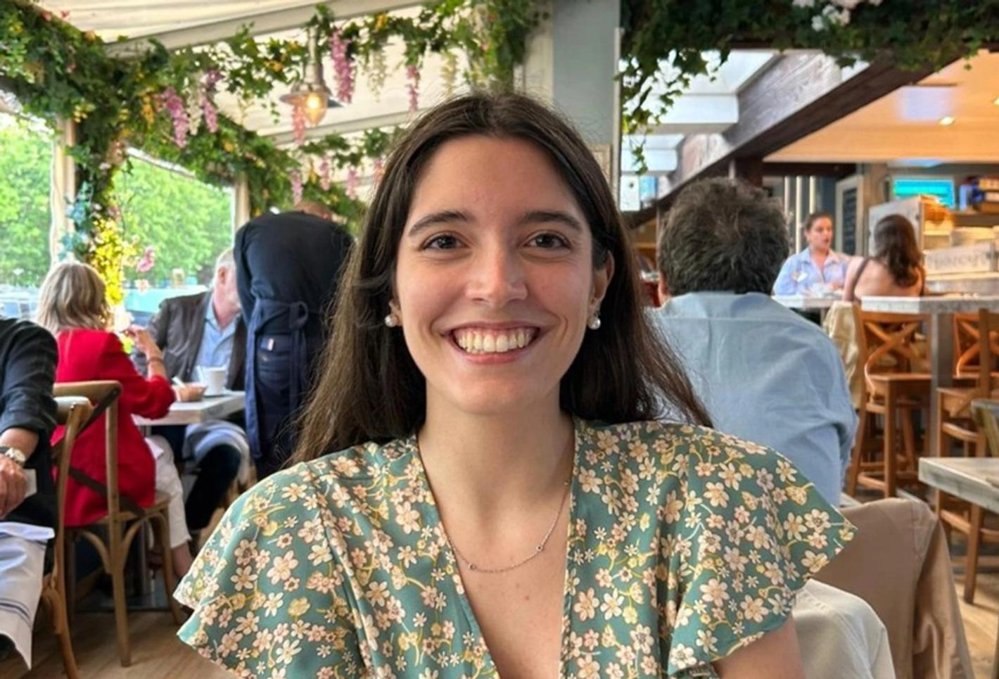 Arianna Magnanini smiling and sitting at a restaurant table