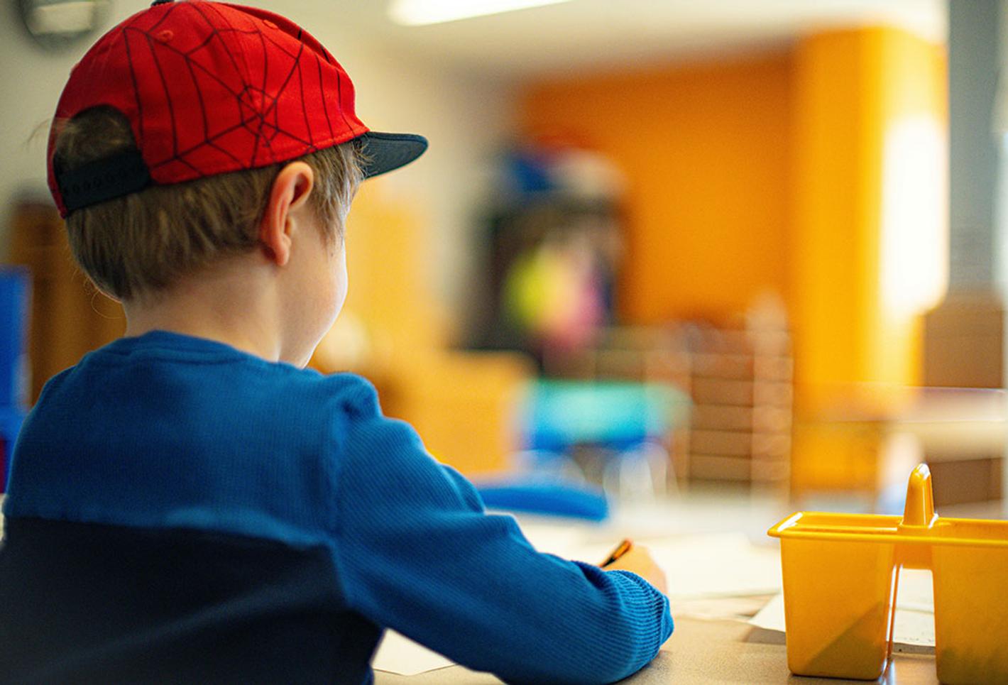 A young boy sat down doing work