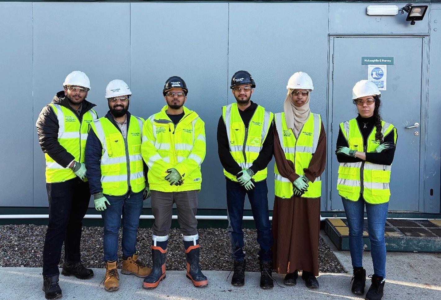 Students look at camera on a construction site
