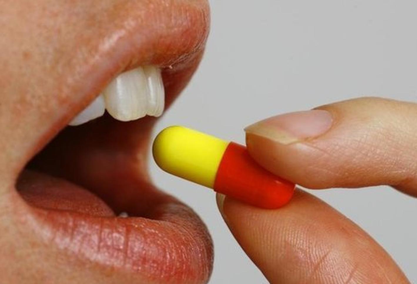 Swallowing red yellow capsule