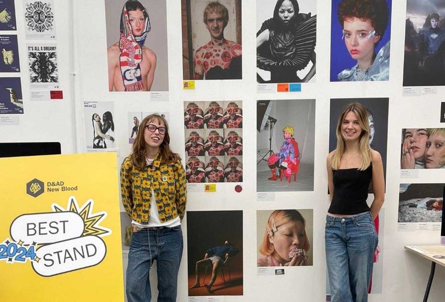 Two students show a display of student artwork