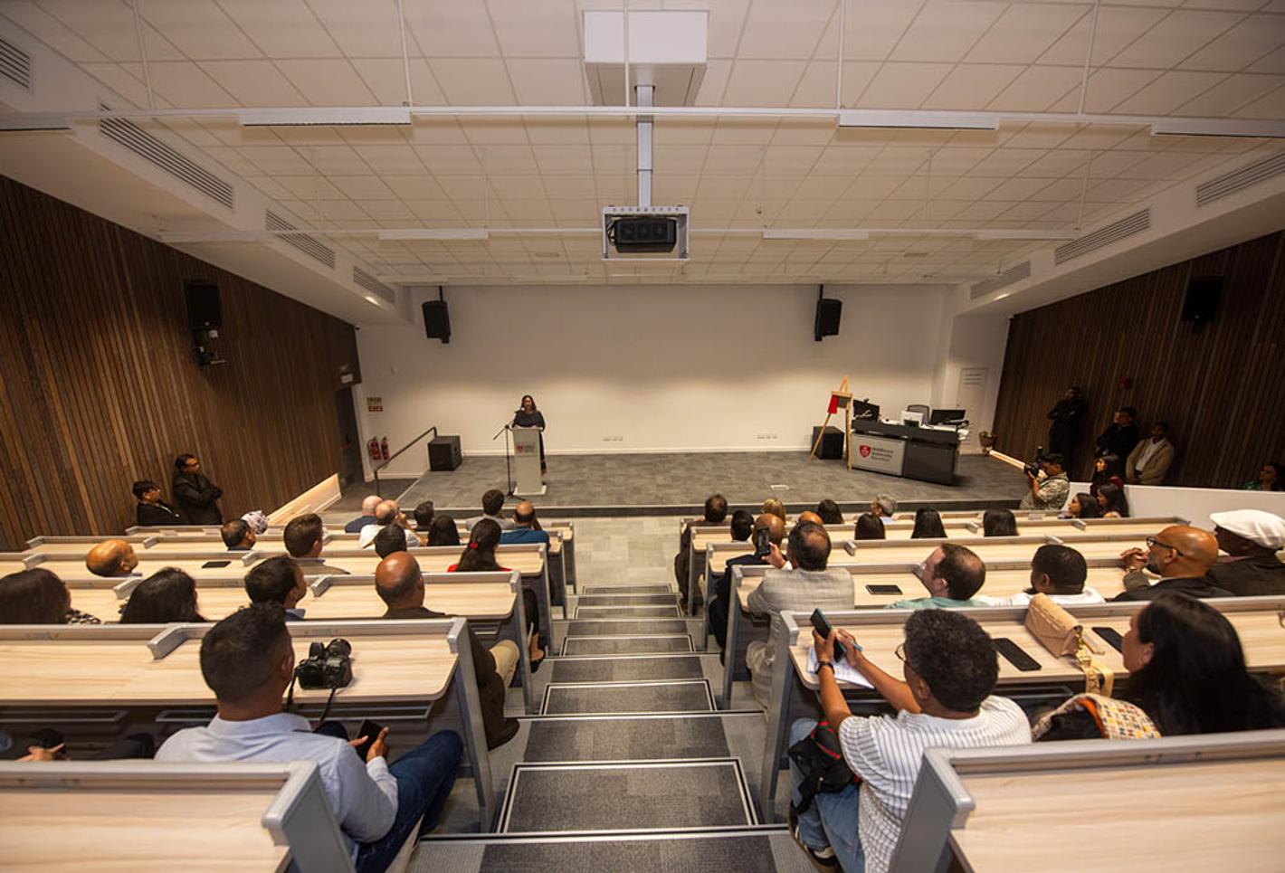People sat in lecture theatre looking at a screen