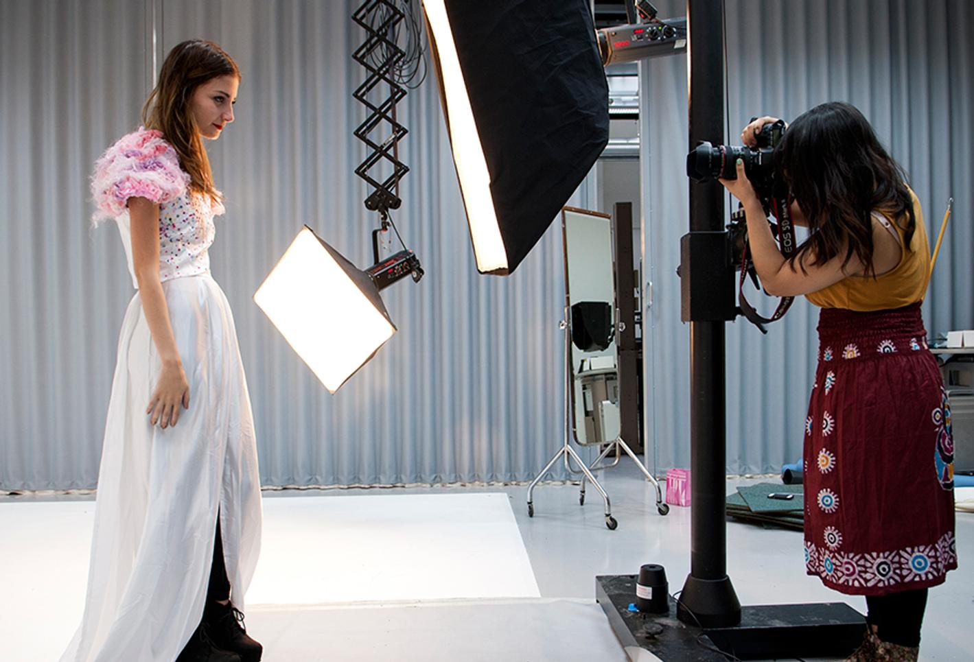 A photographer taking a photo of a model