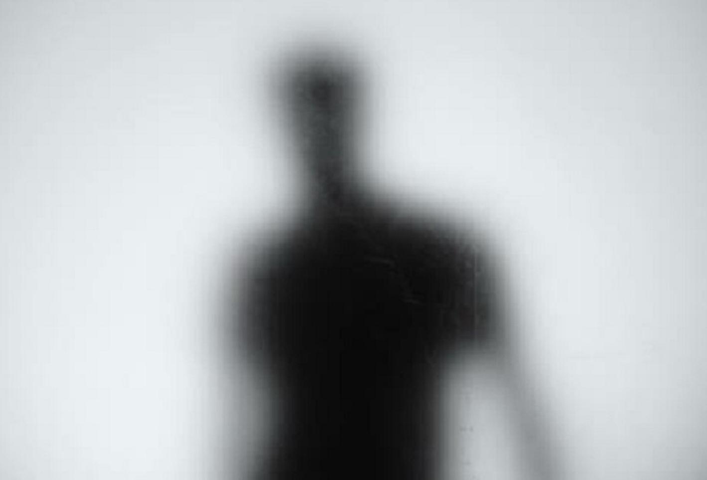 A blurry silhouette standing in the distance