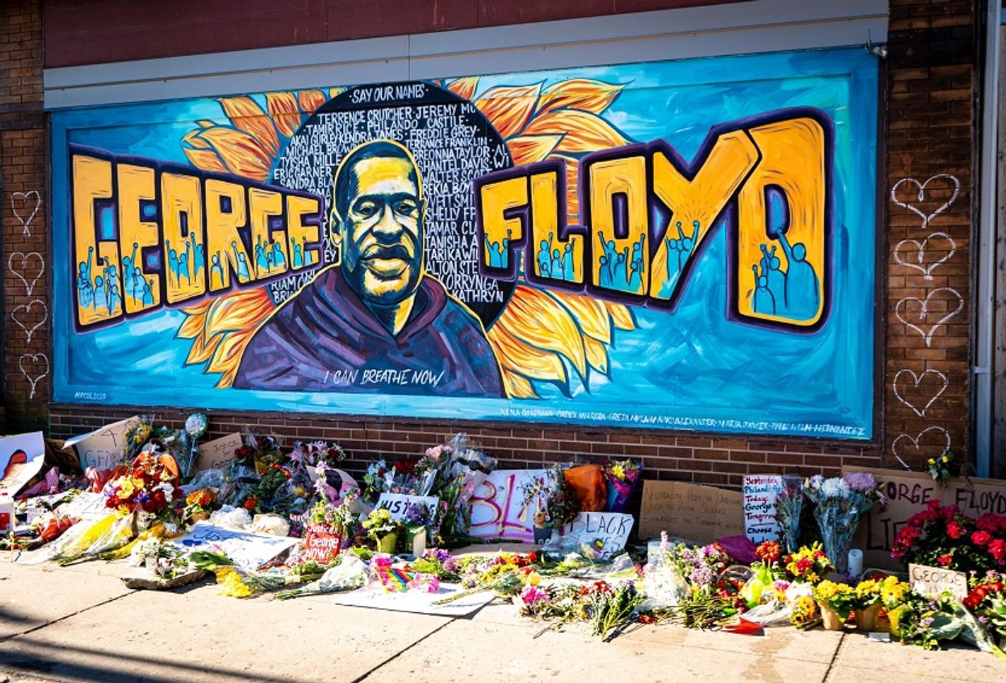 Mural in Chicago honoring George Floyd, featuring vibrant colors and powerful imagery.