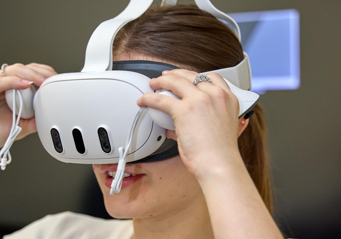 A young woman wearing a VR headset