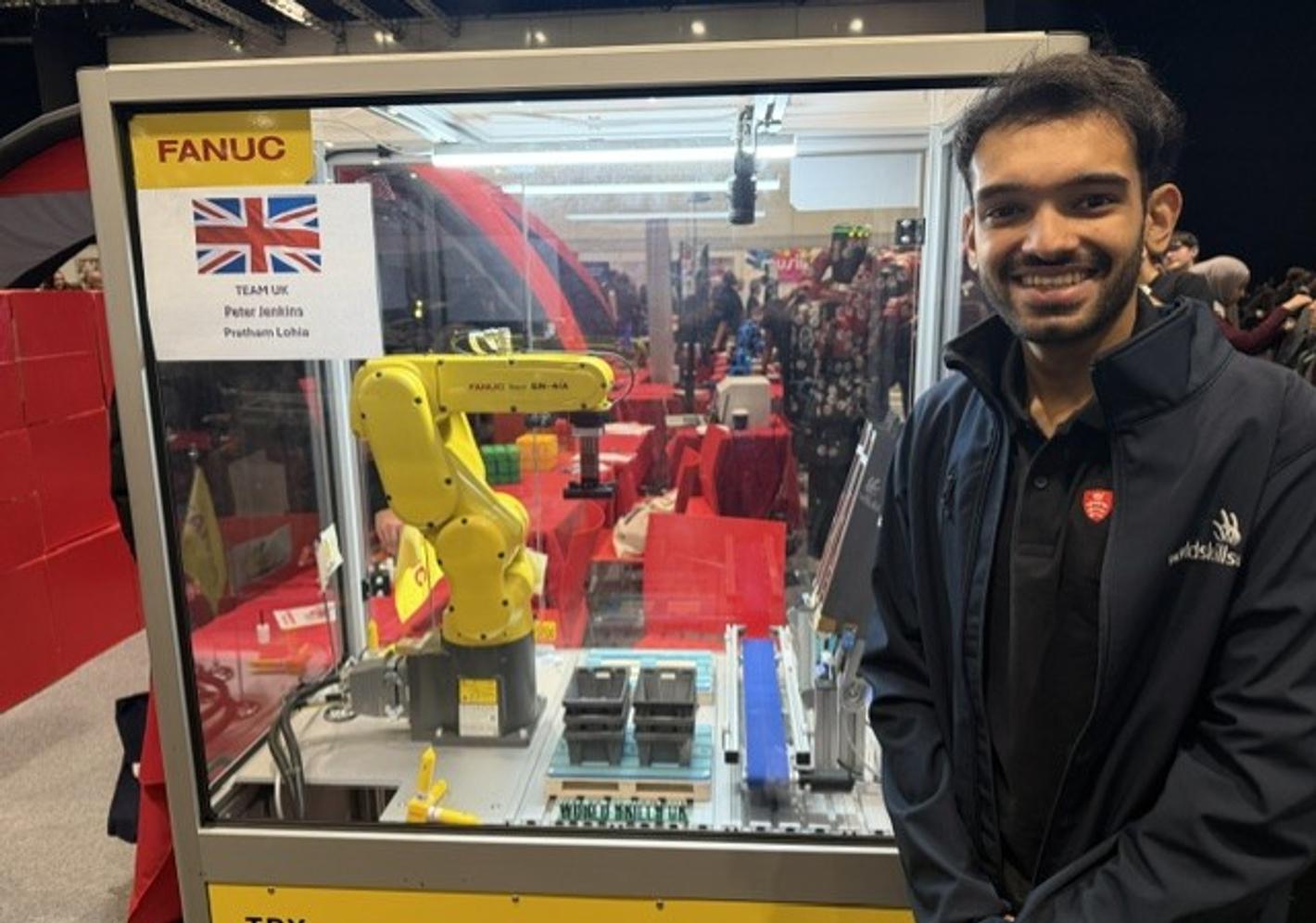 Student Pratham Lohia with FANUC robot