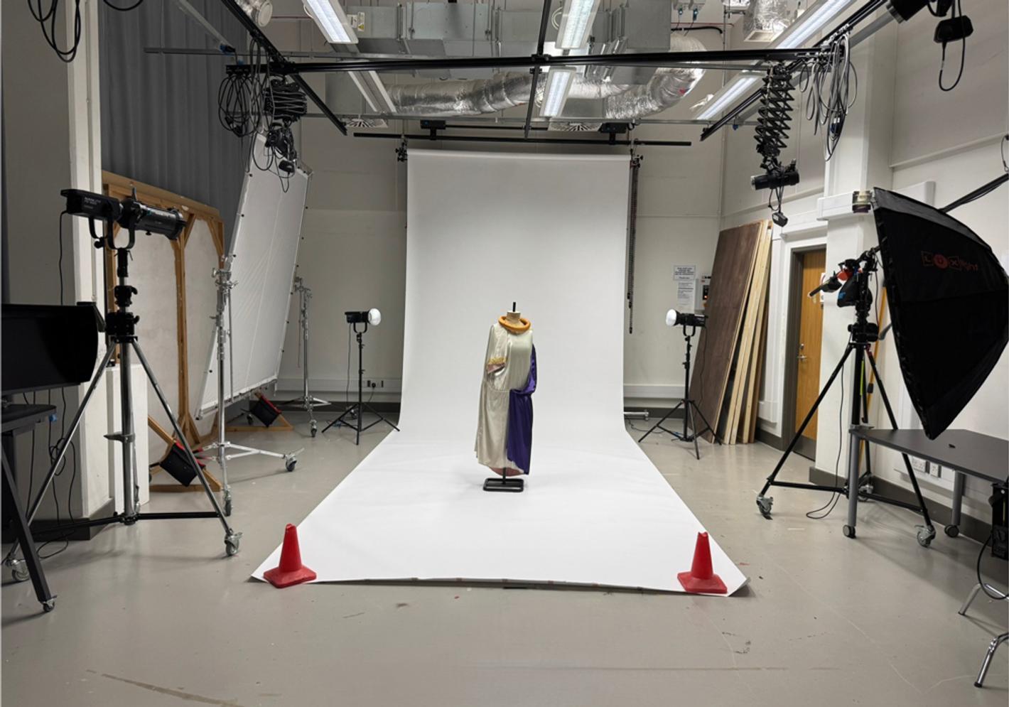 A photographic studio with a white backdrop and a fashion mannequin at Middlesex University