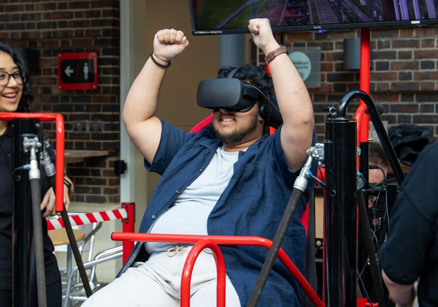 A male uses a VR headset to interact with a computer game