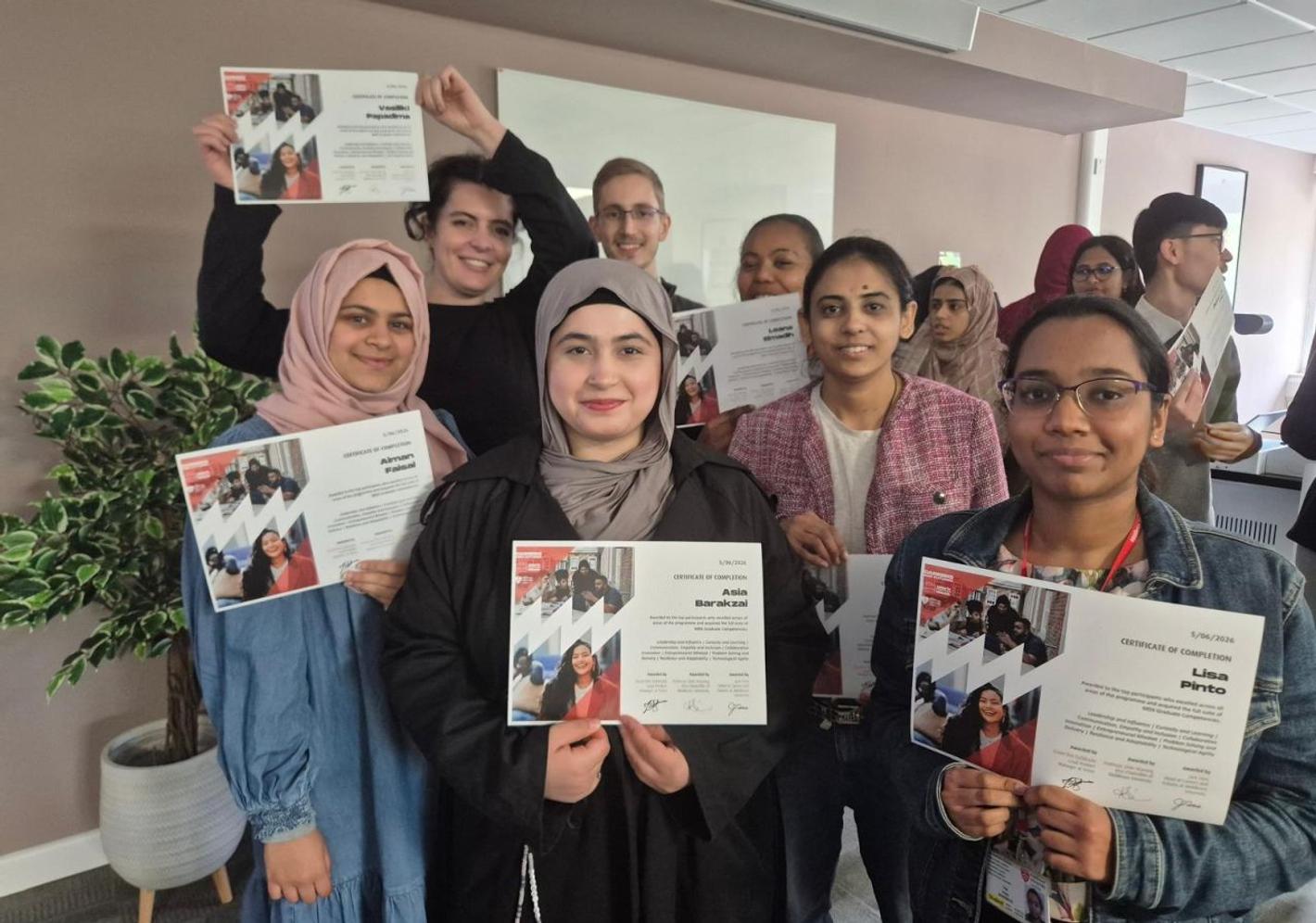 A diverse group of students proudly holding certificates after completing a work experience week at 91��Դȫ�� University. The programme focused on employability skills, workplace experience, professional development, and career preparation.