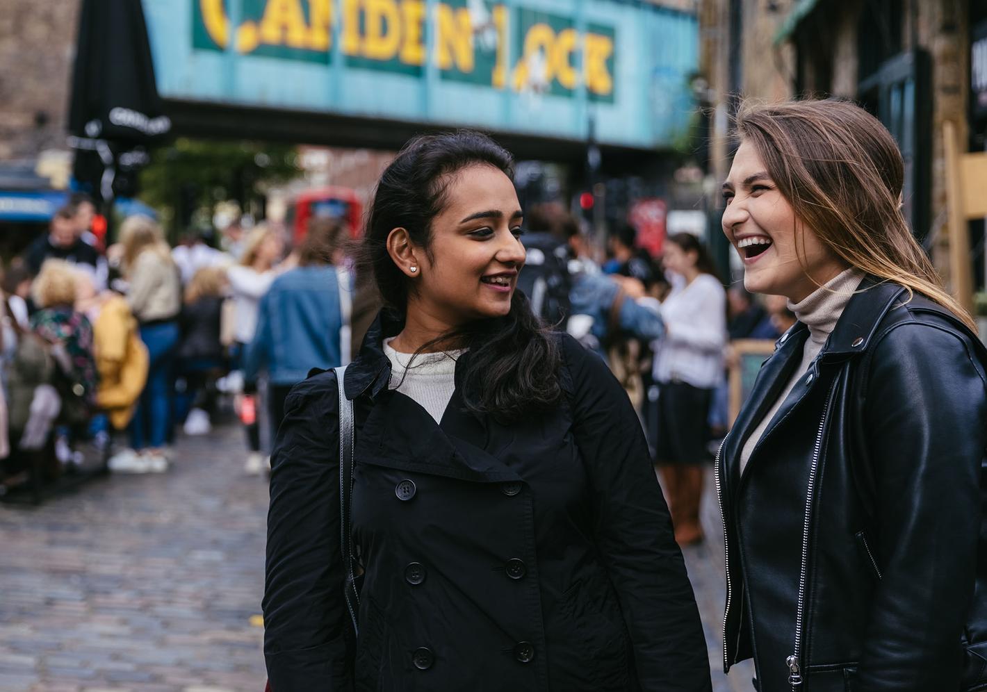 Two students in Camden market laughing