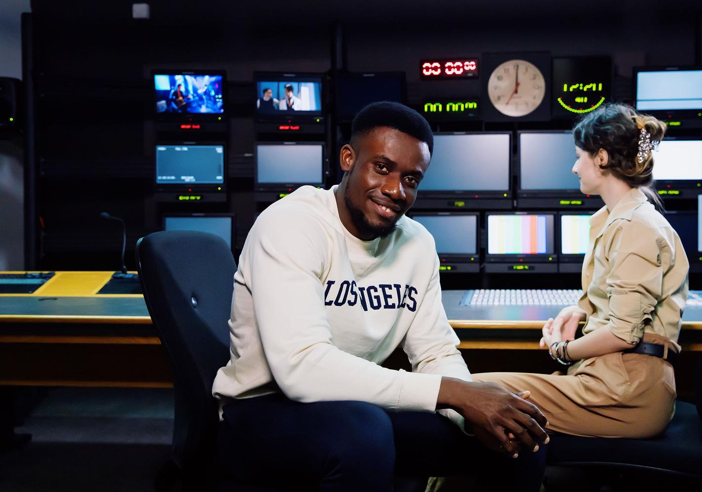Two students sitting in TV studio
