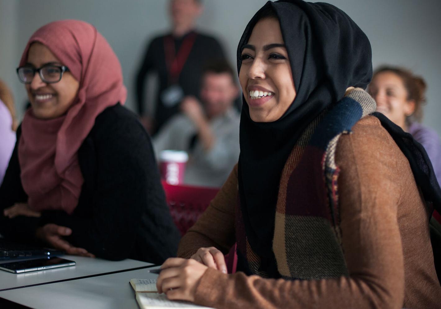 Female students wearing hijabs attending an education studies class
