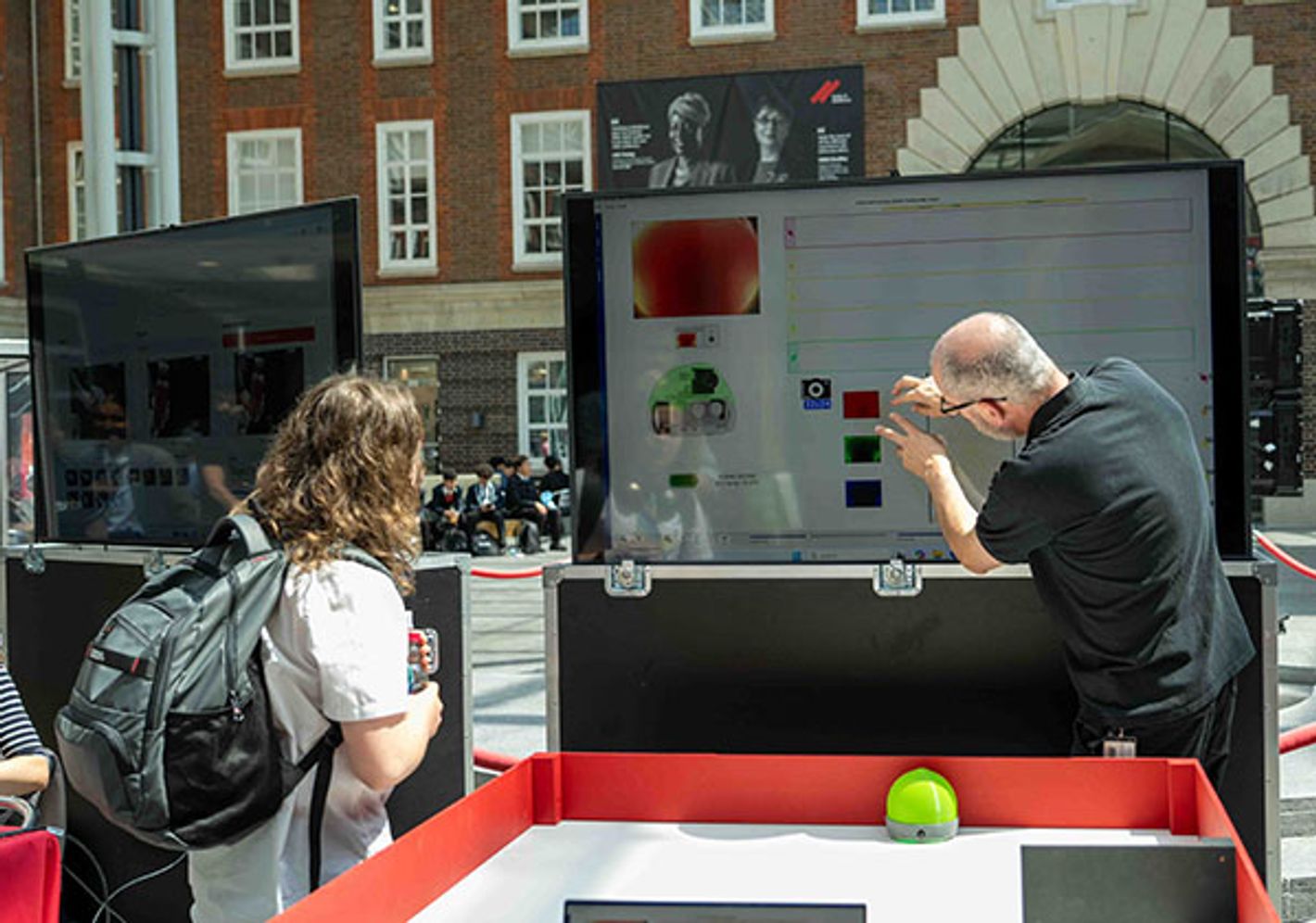 Tutor explains robotic display to pupils at Science and Technology day at Middlesex University.