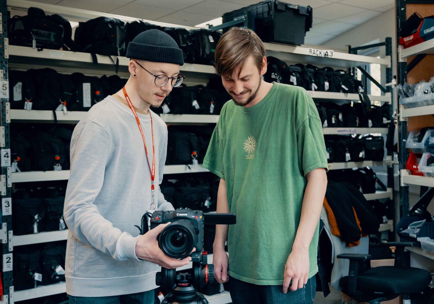 Two film students handling a camera