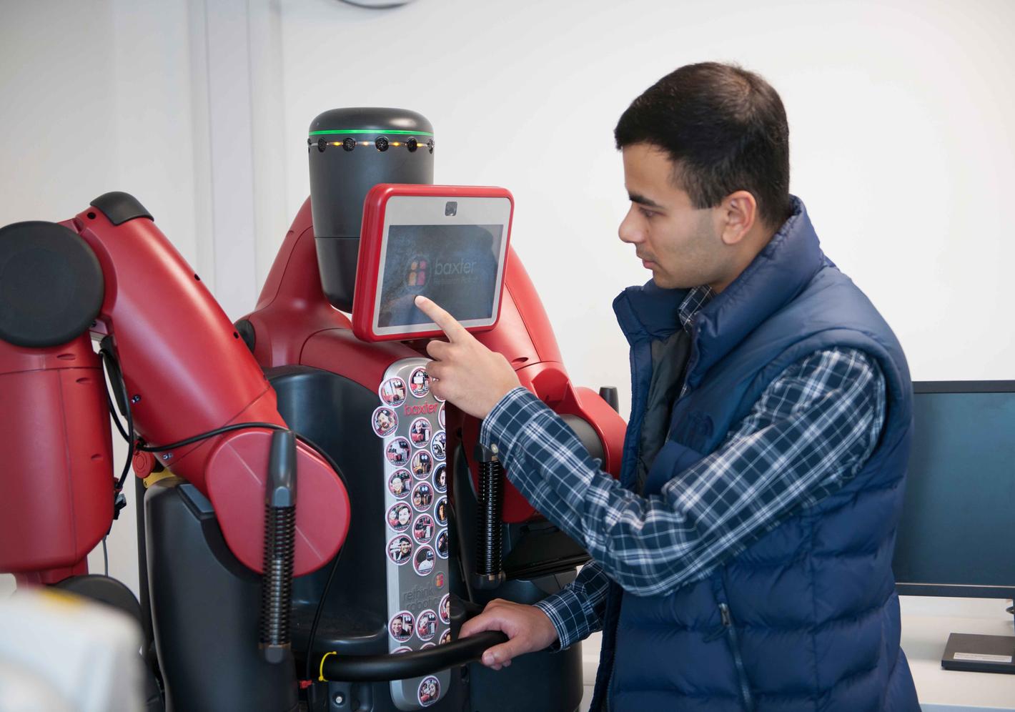 A student working with a large robot
