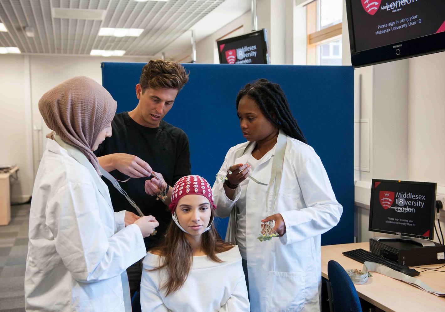 Students putting sensors onto another students head