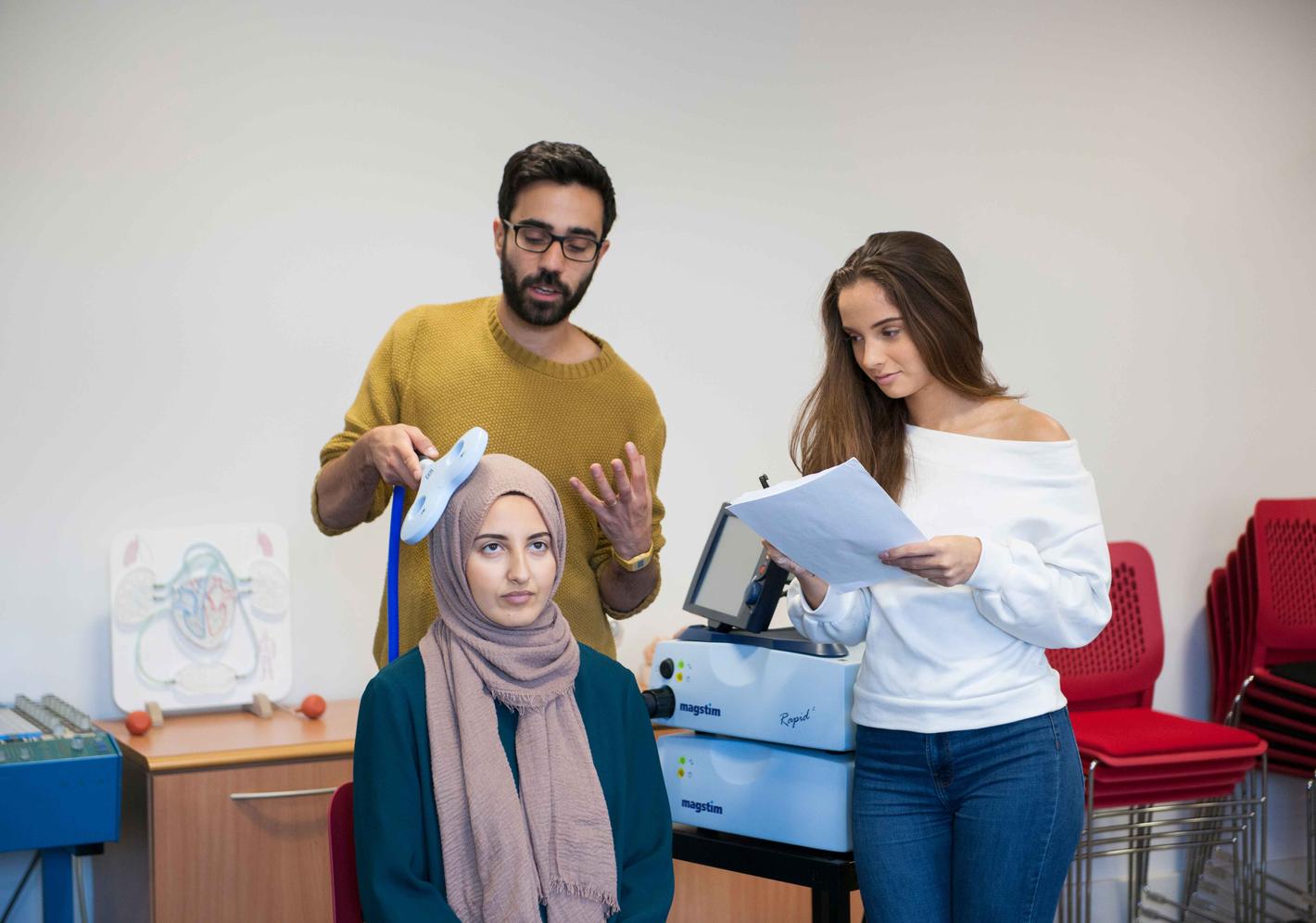 Psychology students scanning another students brain