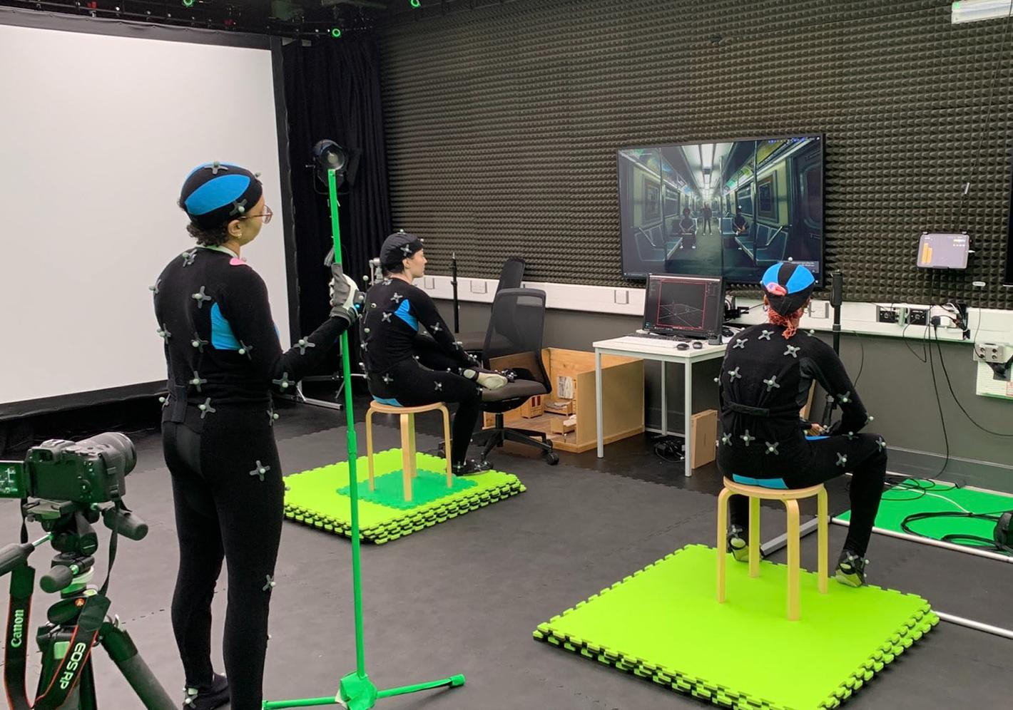 students in motion capture studio watching playback