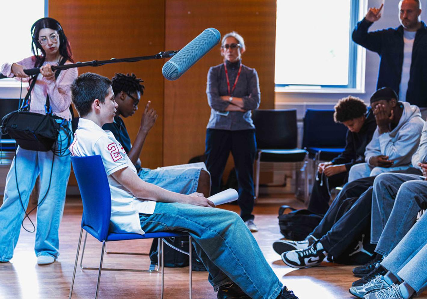 Group of young boys recording a discussion for The Boys podcast.