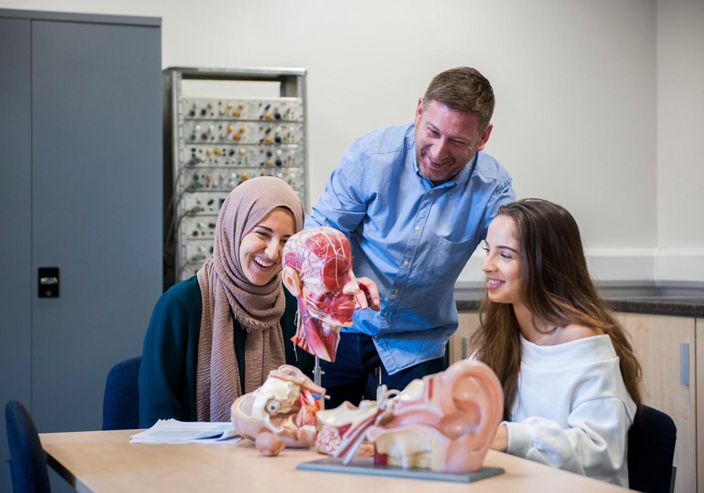 Psychology student examining a model.