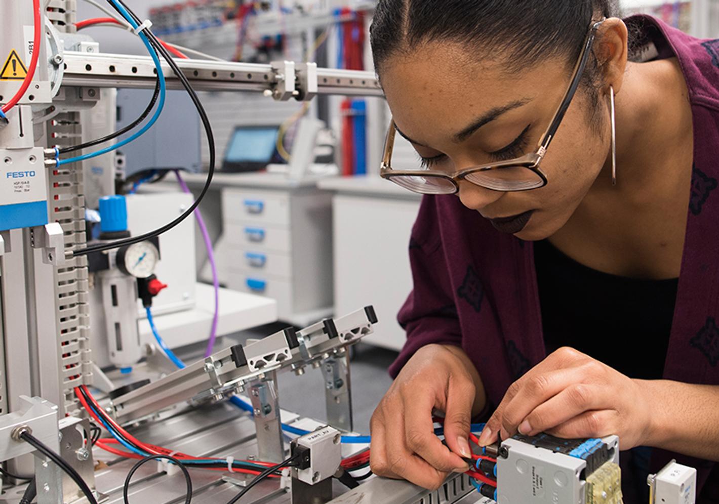A design engineering project showcasing a complex mechanical system with gears, levers, and electronic components.