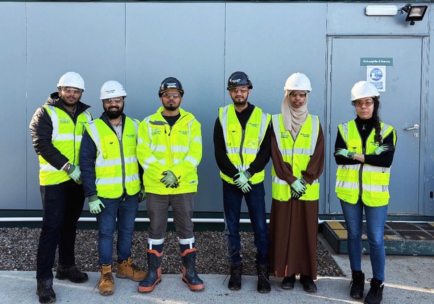 Students look at camera on a construction site