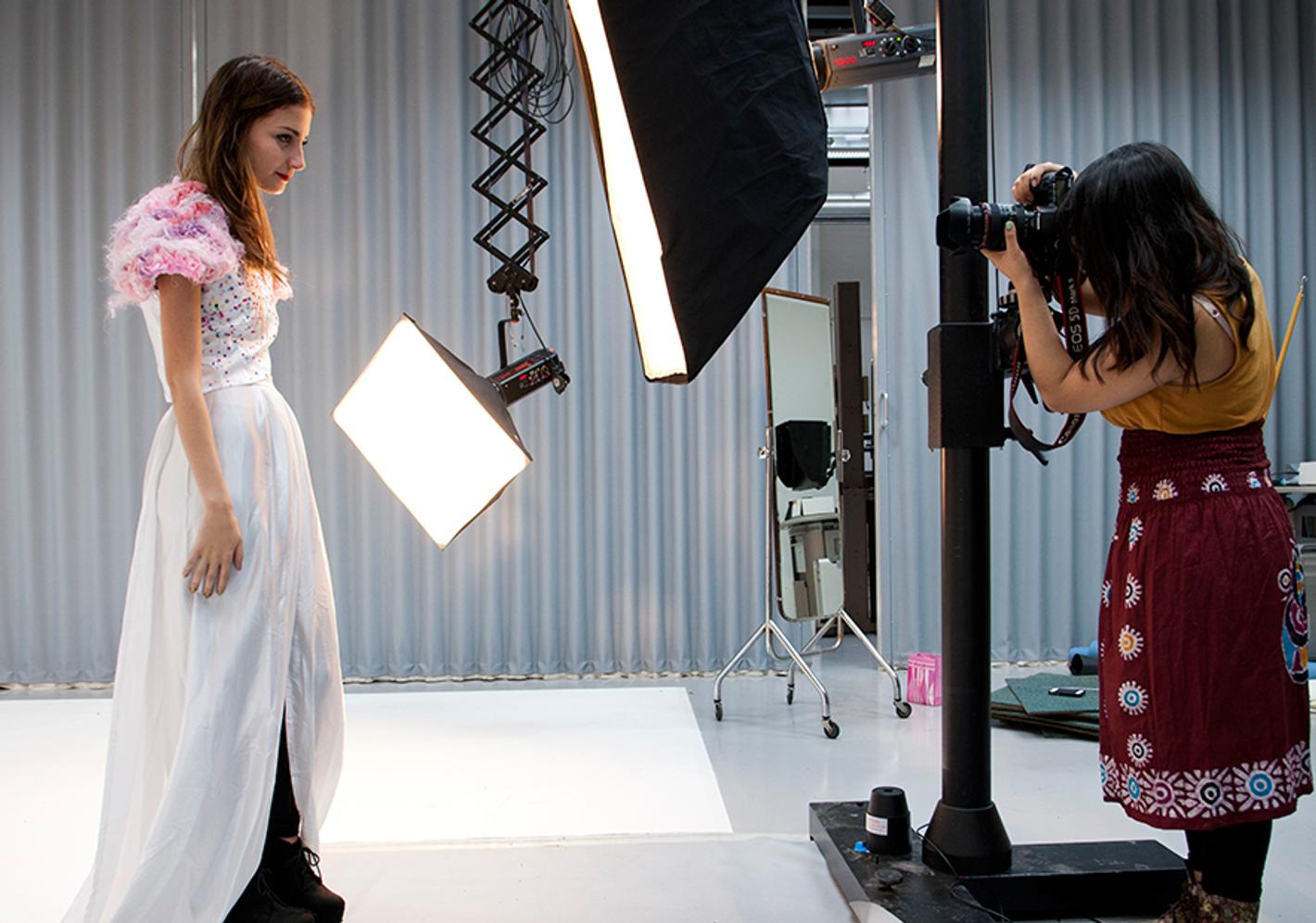 A photographer taking a photo of a model