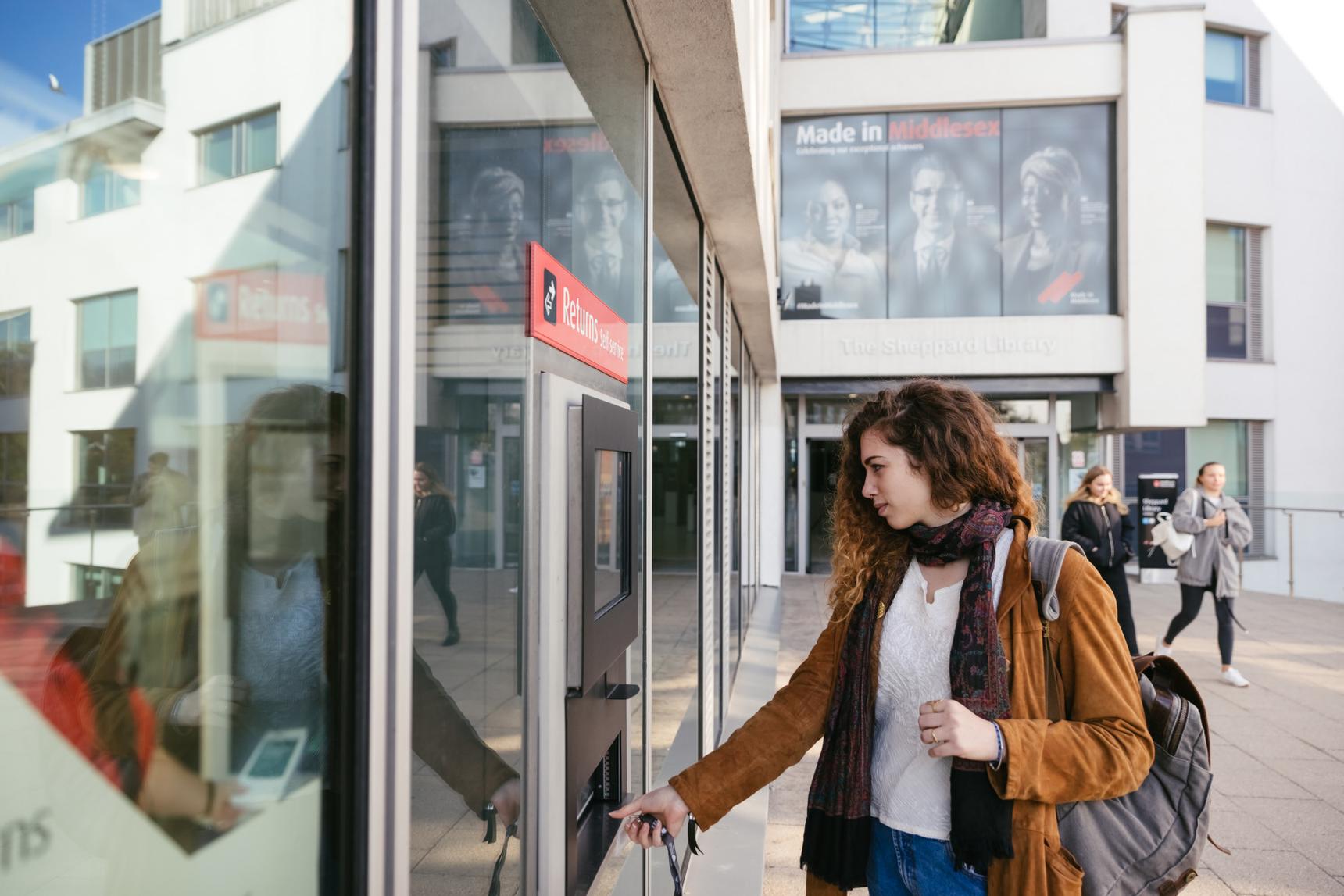 A woman standing in front of a building.