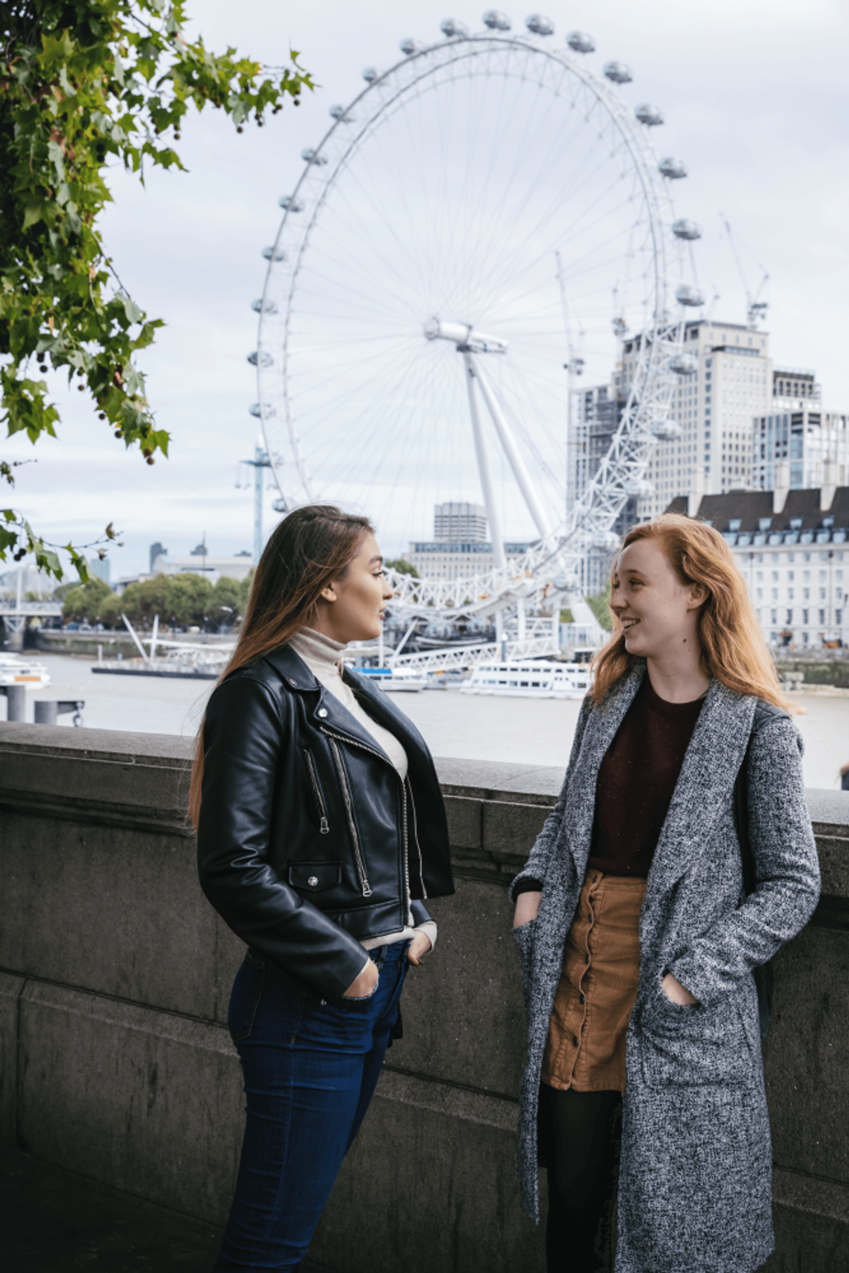students by the river Thames, next to Westminster Bridge, London eye in the background