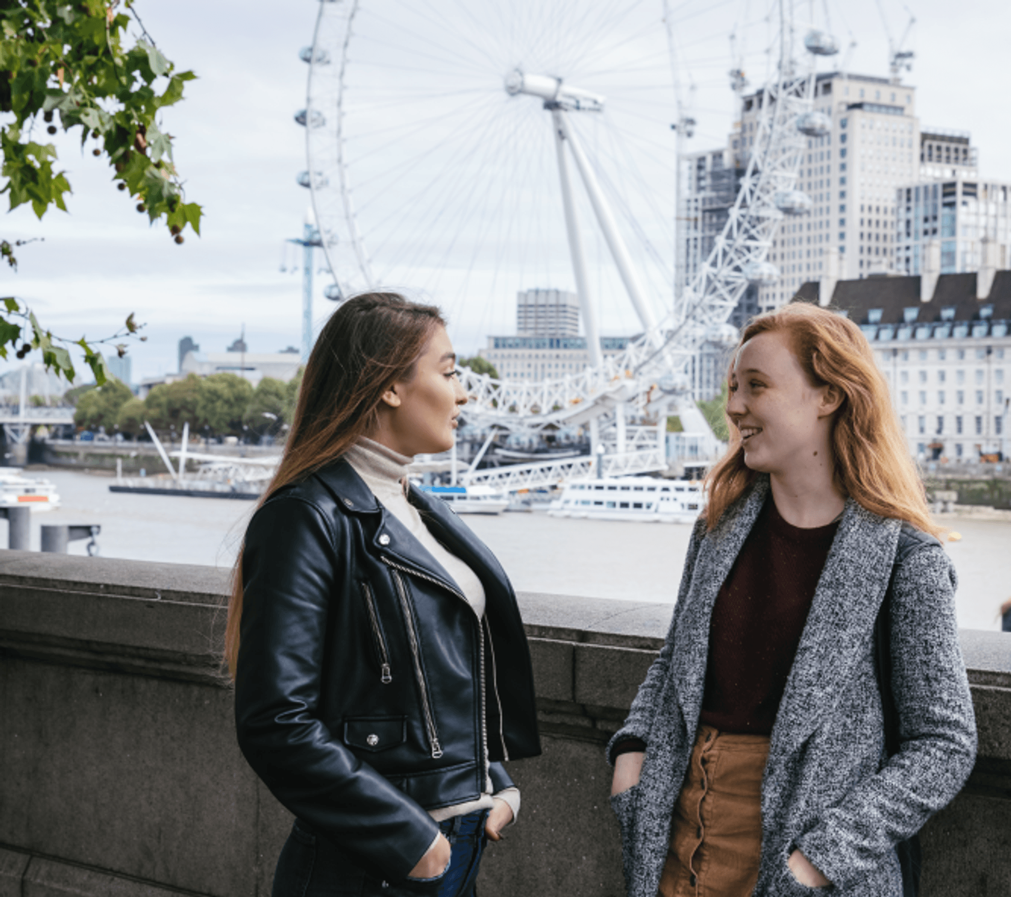 students by the river Thames, next to Westminster Bridge, London eye in the background