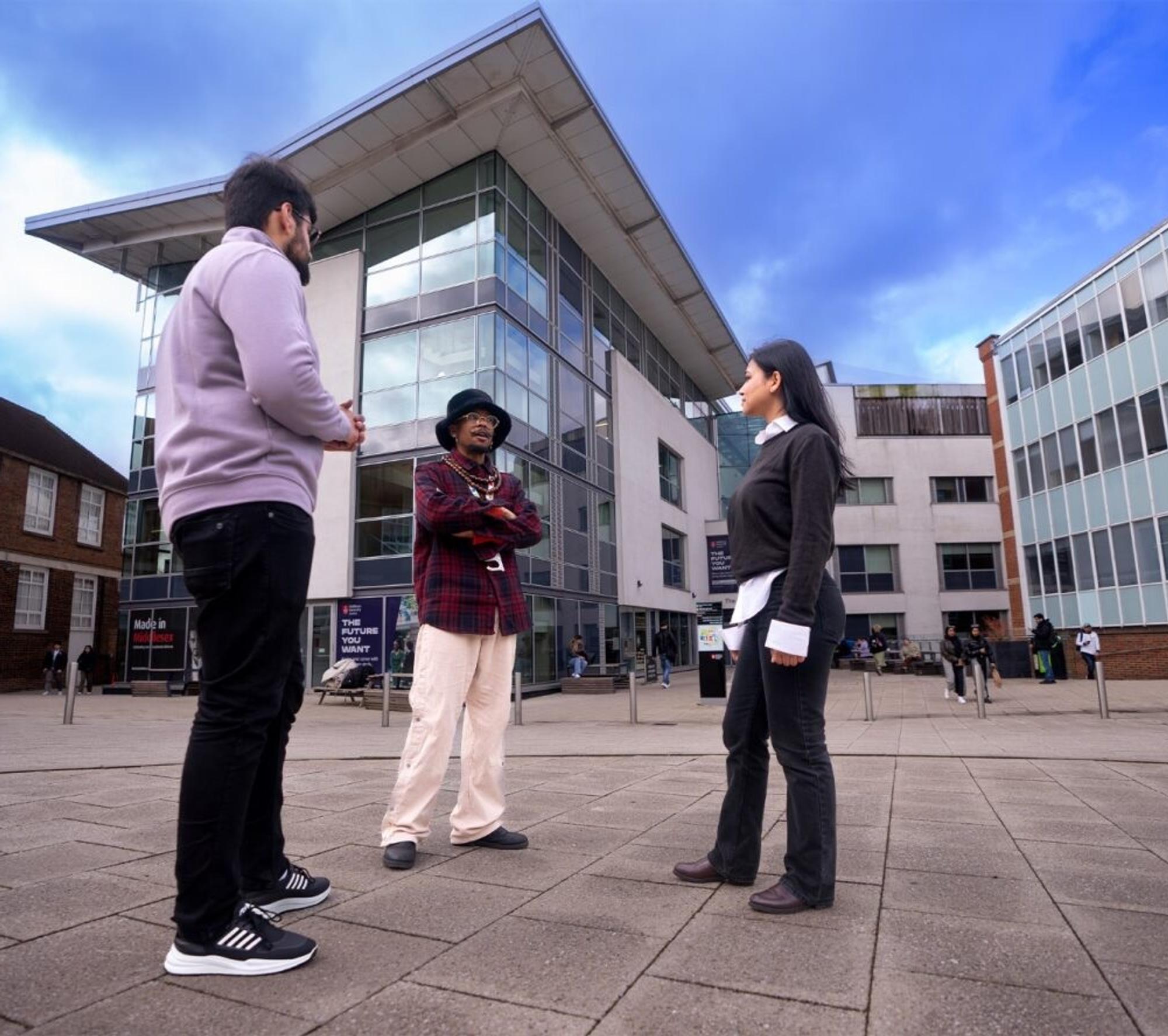 Students standing between buildings