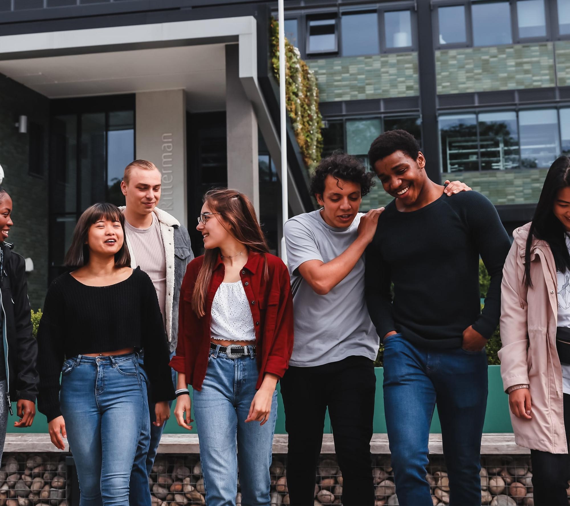 Group of students walking outside on campus.