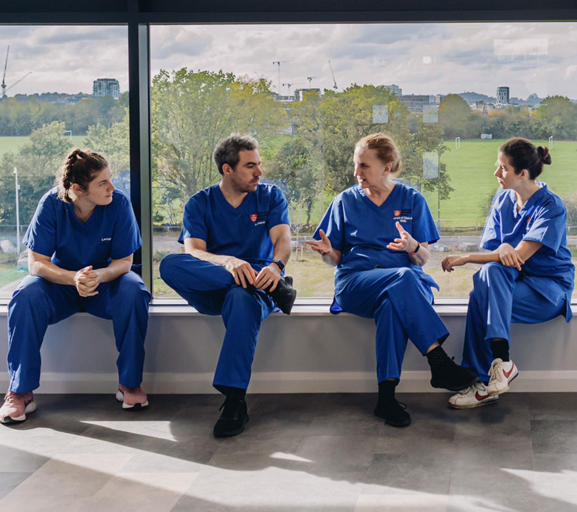 Group of four students sat chatting.