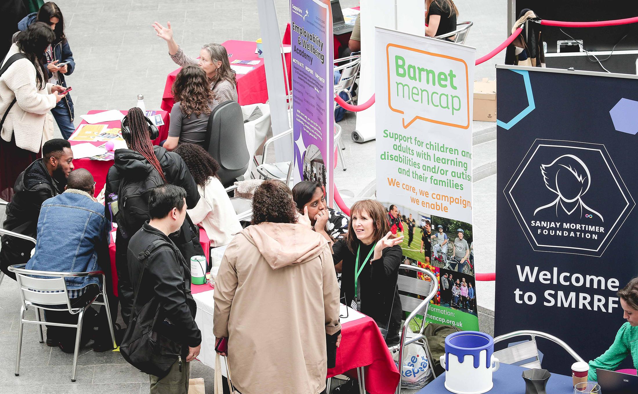 busy festival with stands for Barnet Mencap and Sanjay Mortimer Foundation