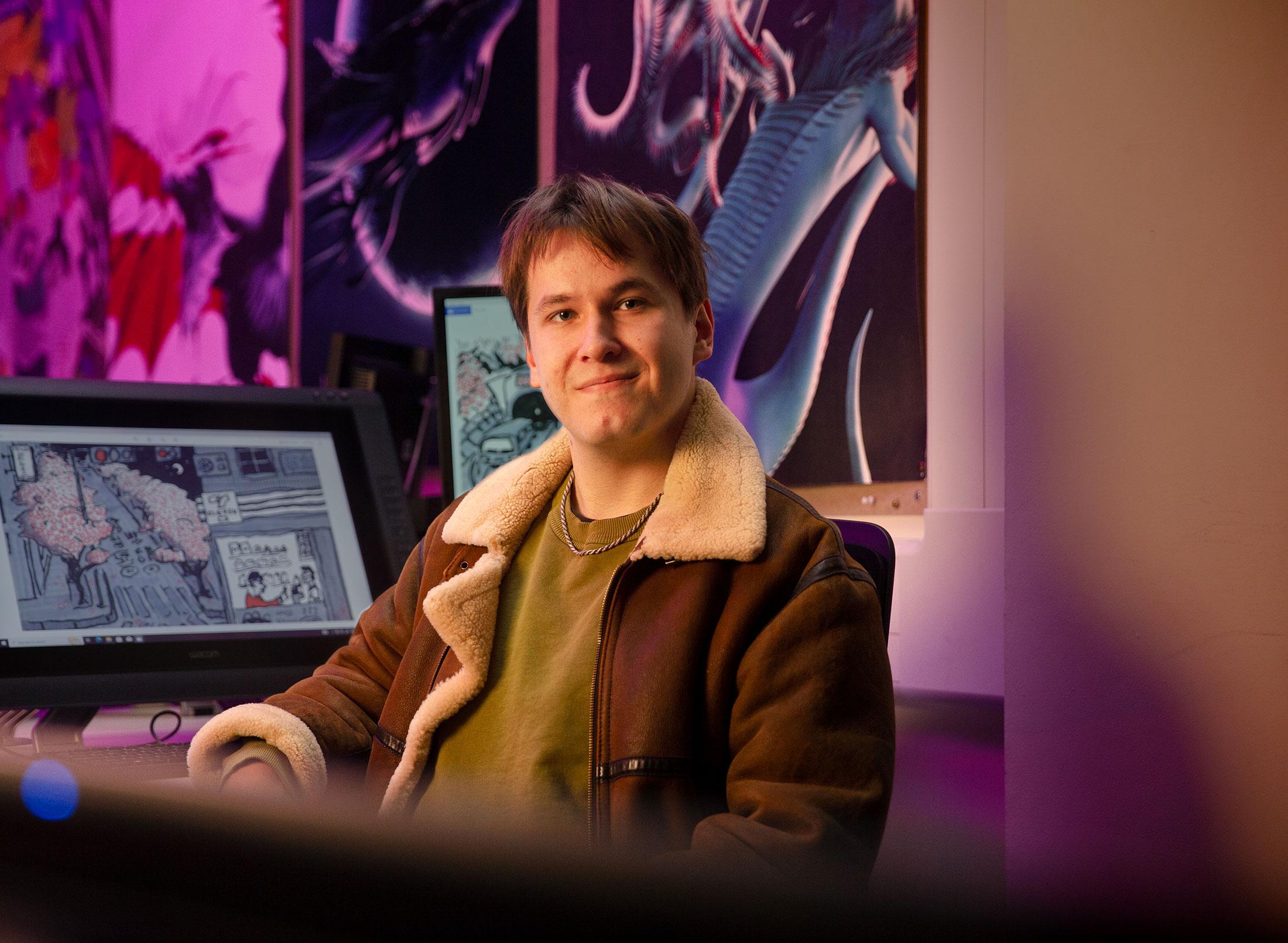 Student sat in front of computer showing work