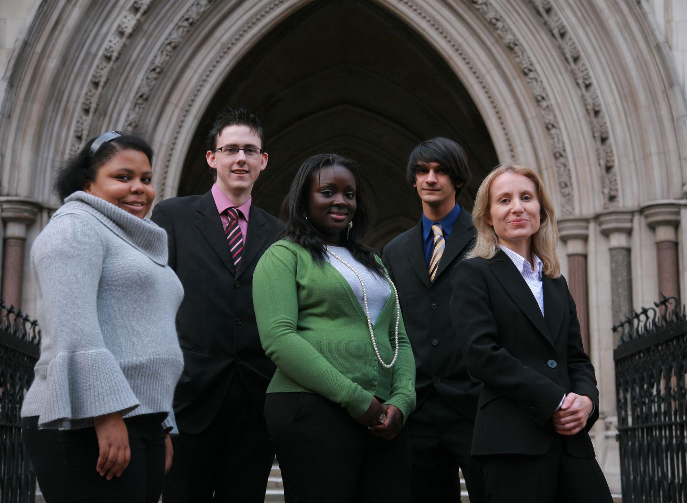 Students smiling in front of a building