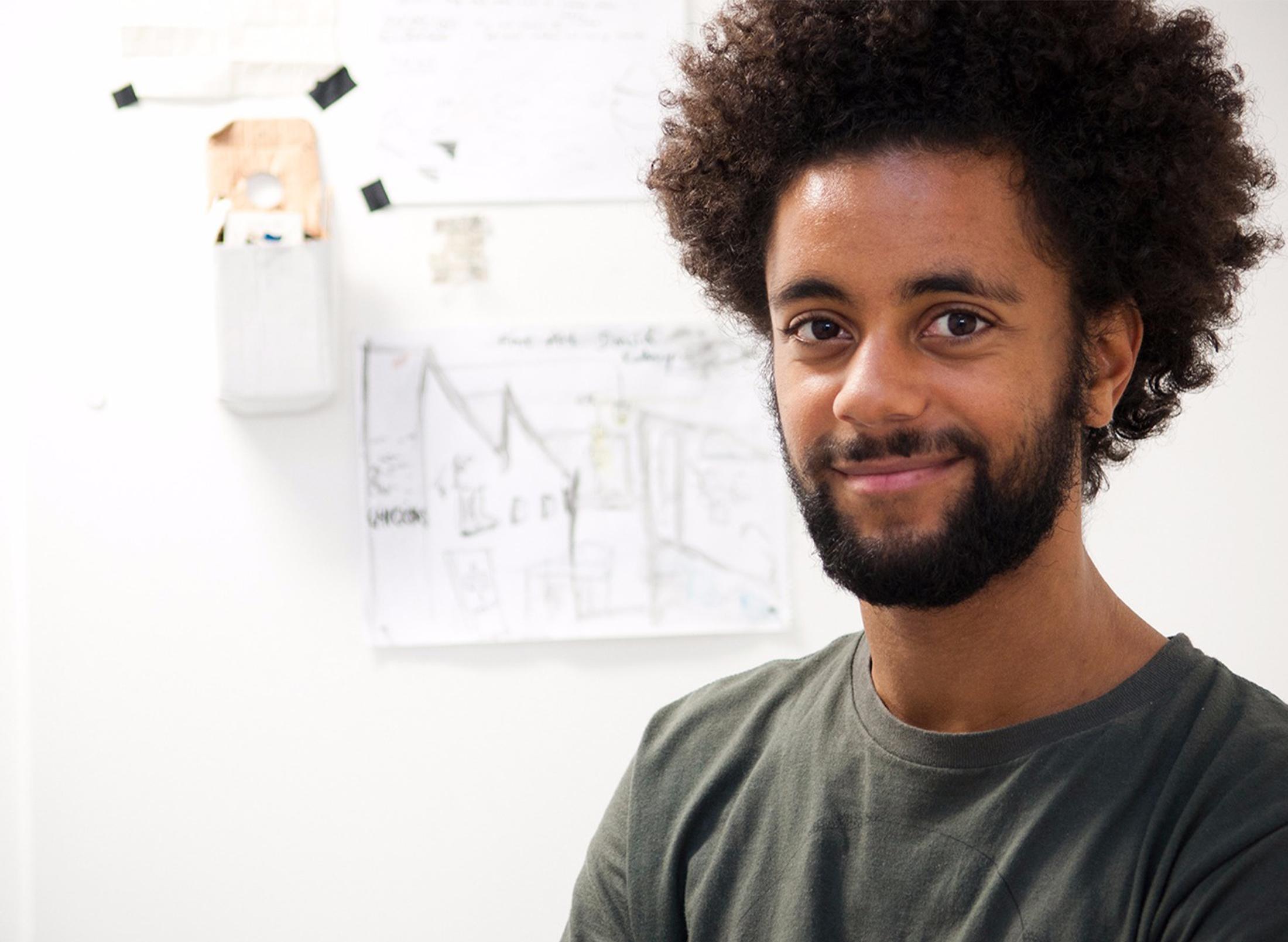 Mixed race student by art board
