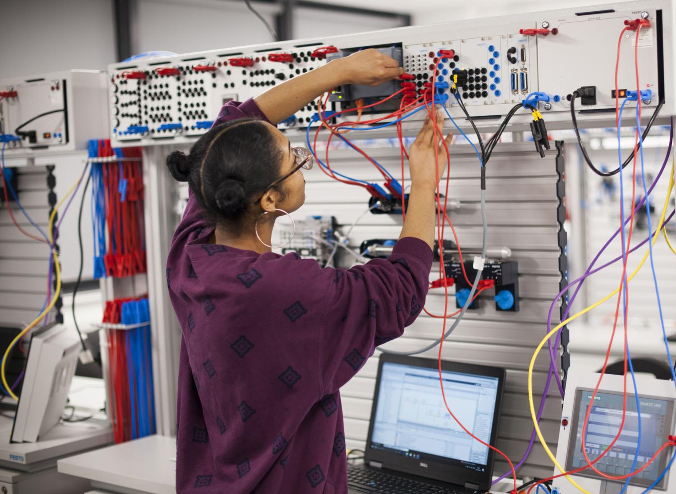 A student plugging in cables