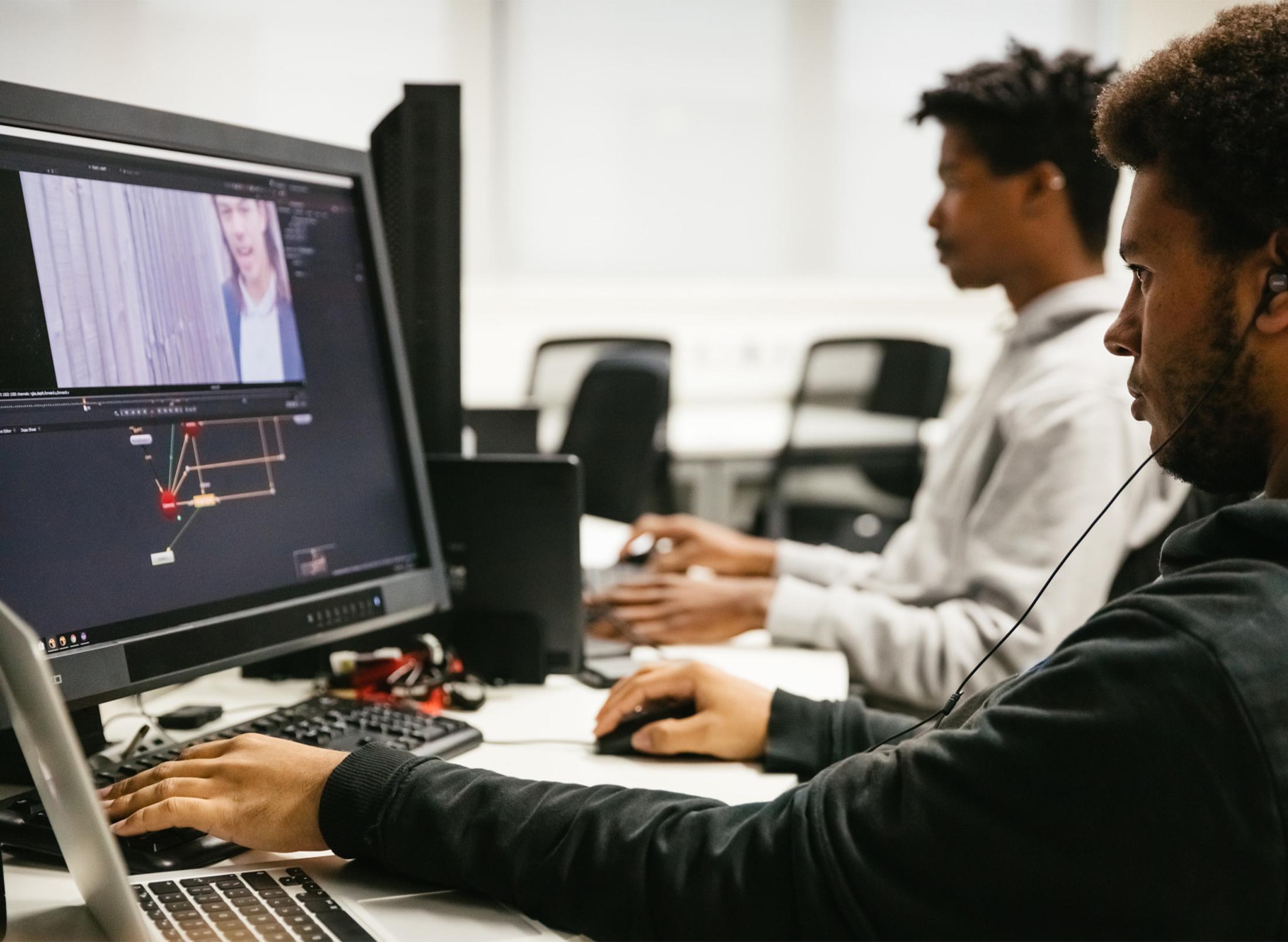 A student designing a game on the computer
