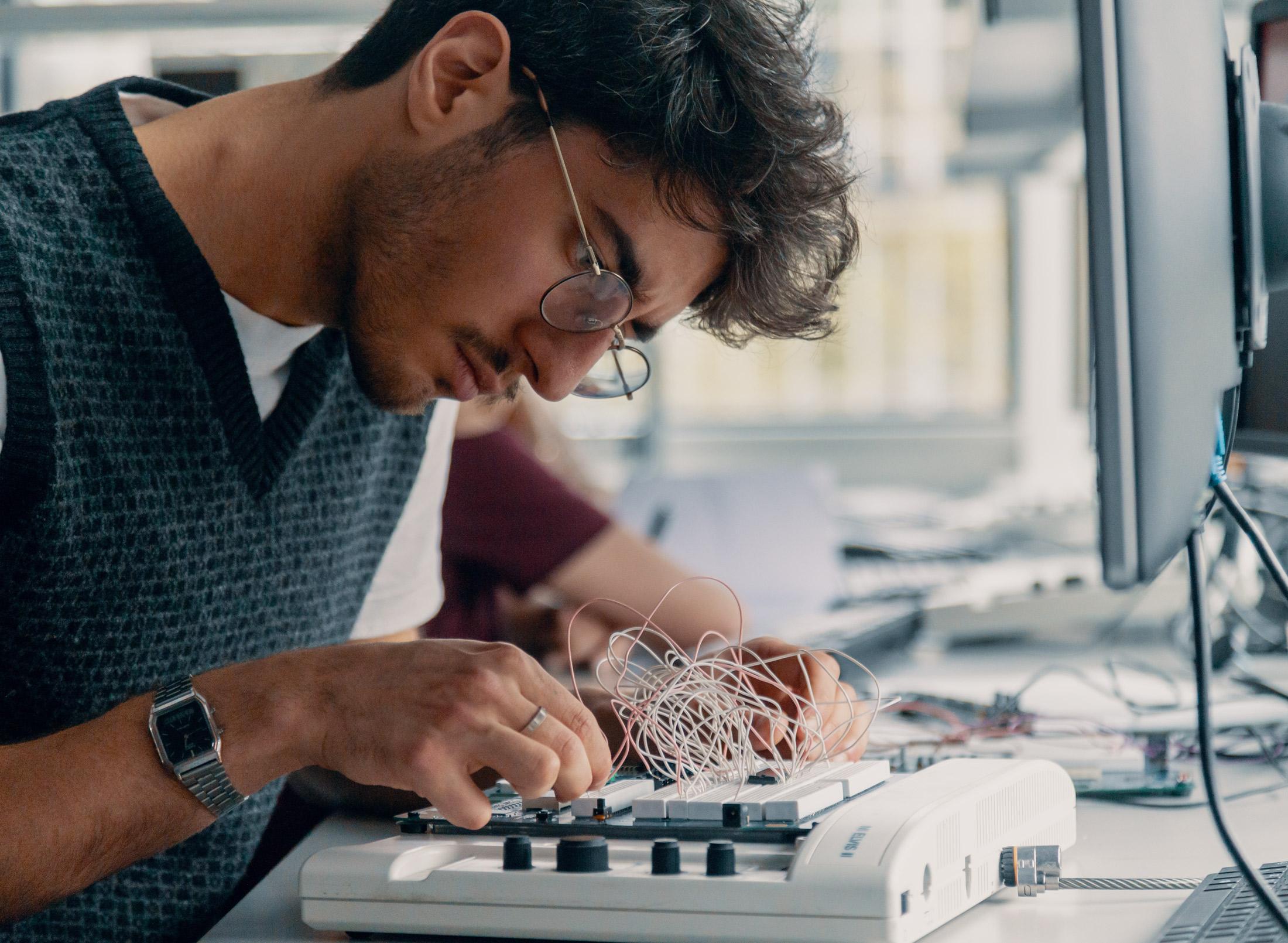 Computer science student working on a pcb