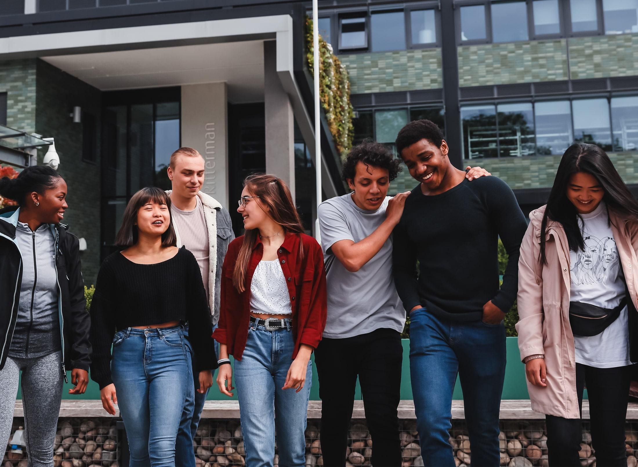 Group of students walking outside on campus.