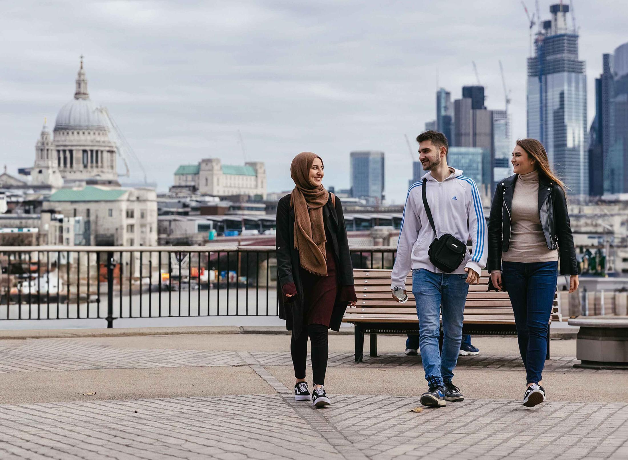 Three students walking in central London