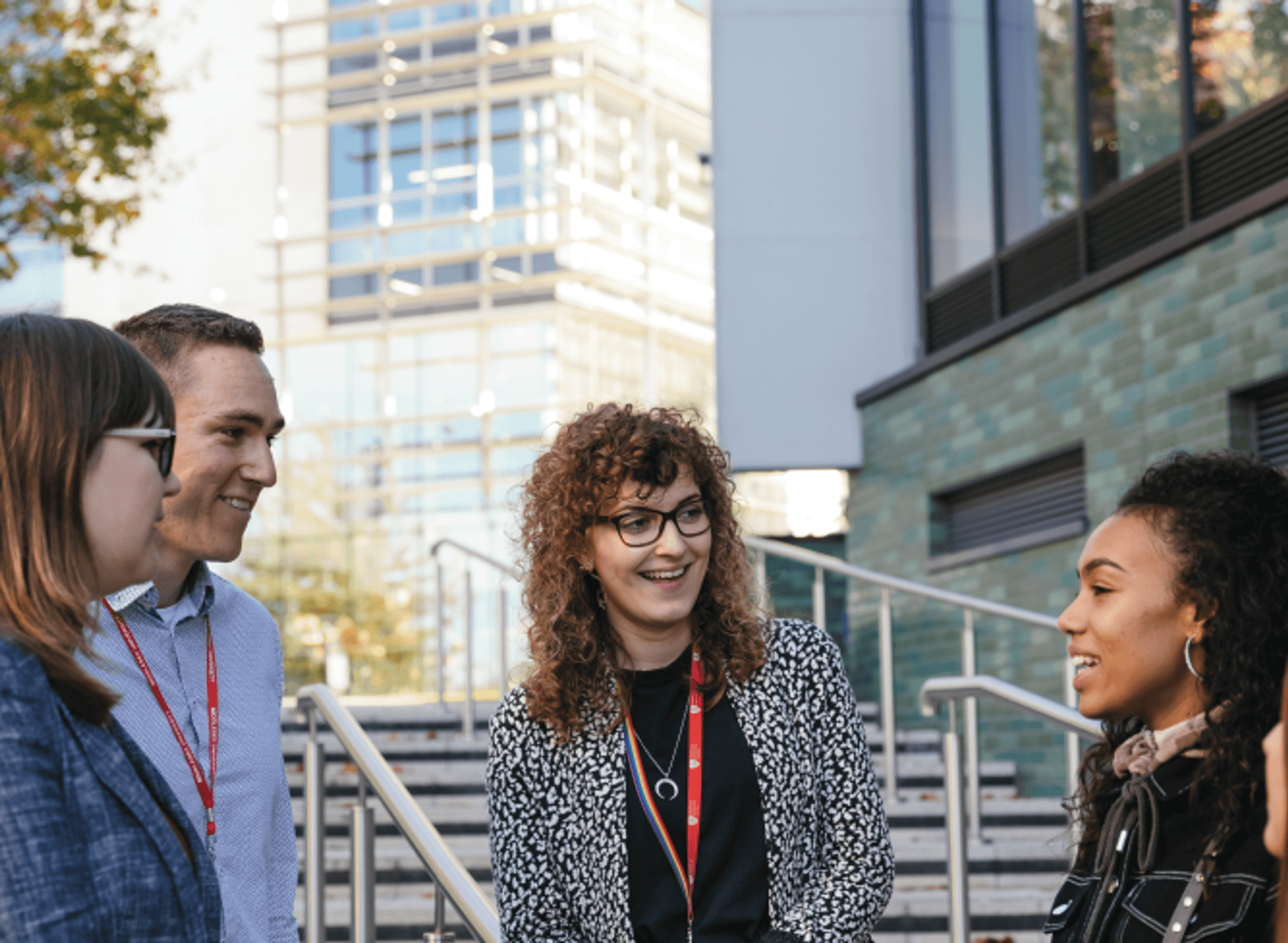 Staff and students talking outside the Ritterman building
