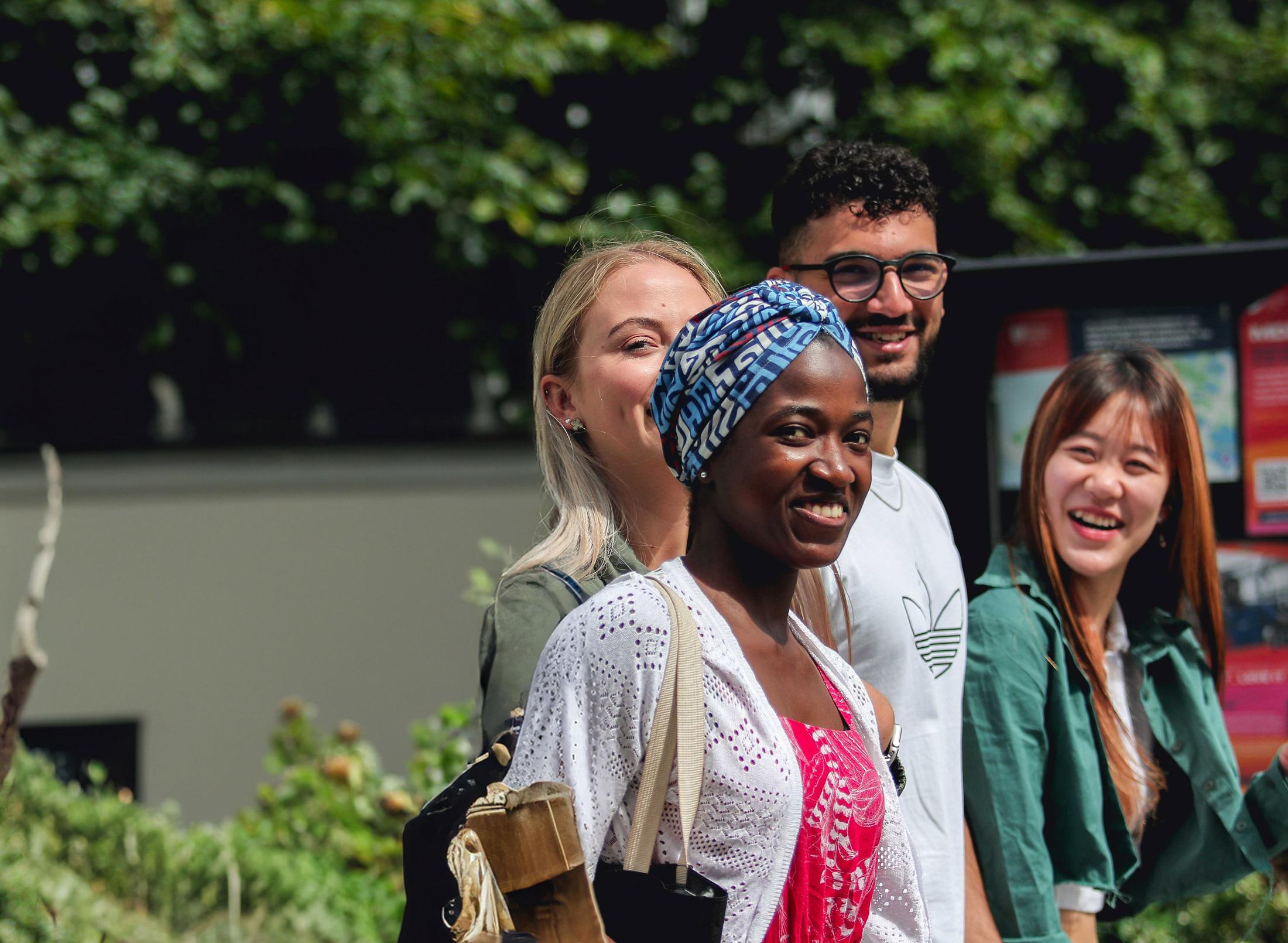 A group of international middlesex university students walk together outside