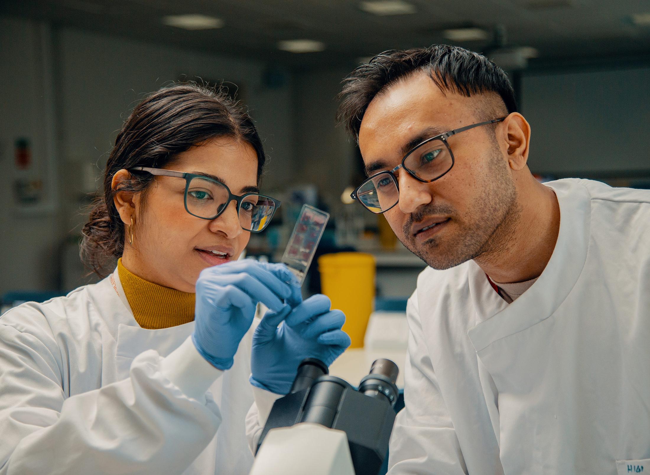Female and male student testing in a lab