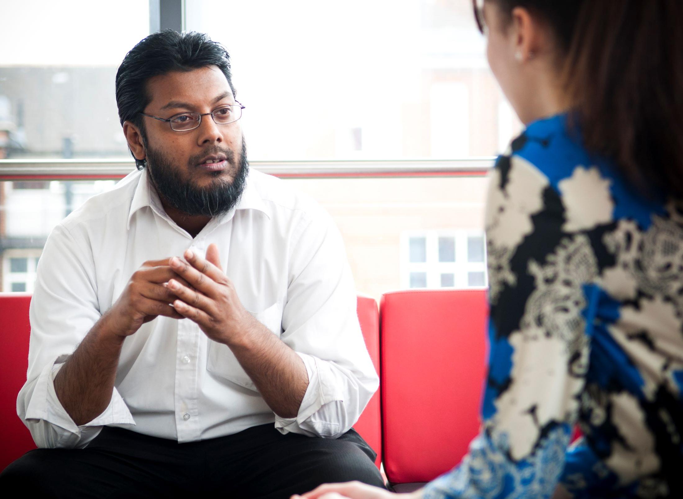 Male student social worker consults a female whose face is hidden